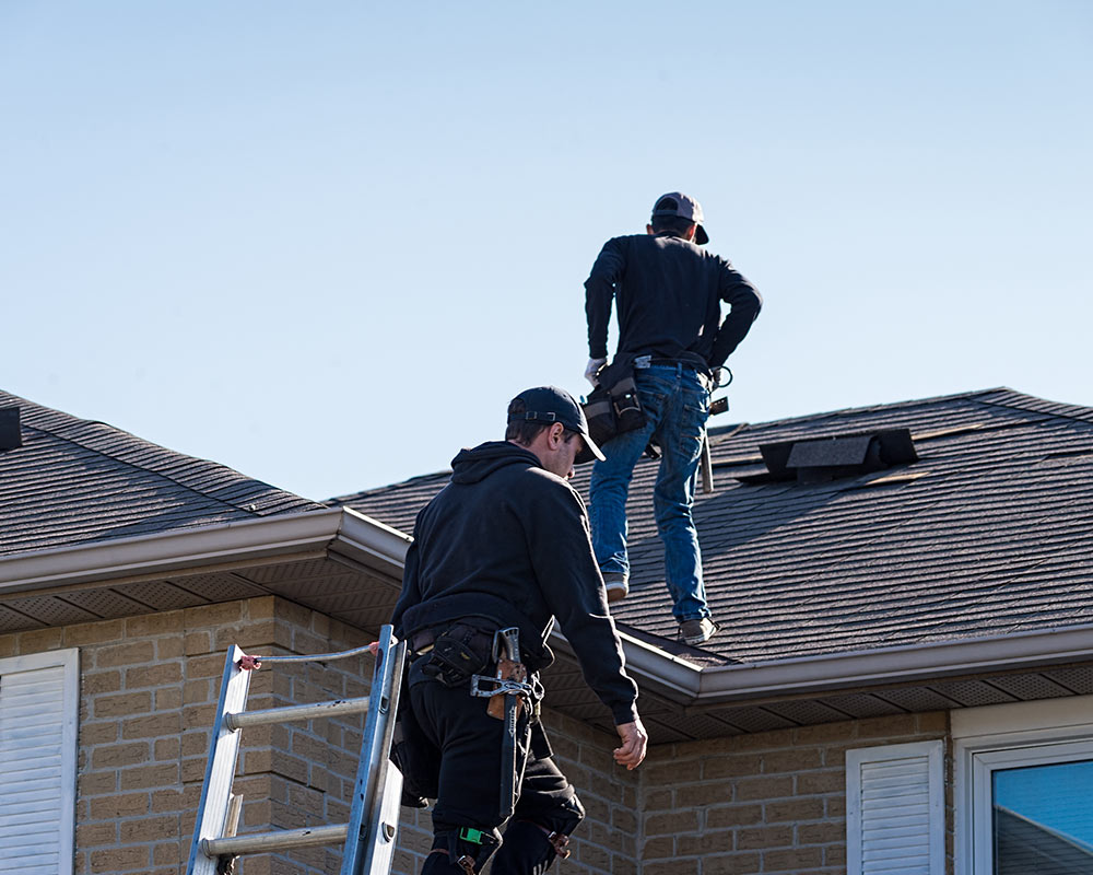 two roofers inspecting roof baton rouge la